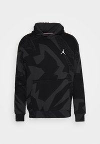 Hoodie noir avec un motif géométrique noir, poche kangourou et un logo Jumpman blanc sur la poitrine. Tissu doux, coupe décontractée.