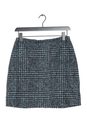 Jupe crayon taille haute noire et bleu sarcelle à motif pied-de-poule suspendue à un cintre noir sur fond blanc.
