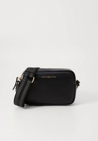 Borsa a tracolla in pelle nera con logo dorato. Texture liscia, forma rettangolare, tracolla regolabile a righe, chiusura con zip e design minimalista.