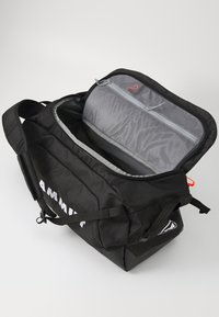 Black duffel bag with textured fabric, zipper closure, gray interior mesh pocket, and red accent. Features side straps and logo detail.
