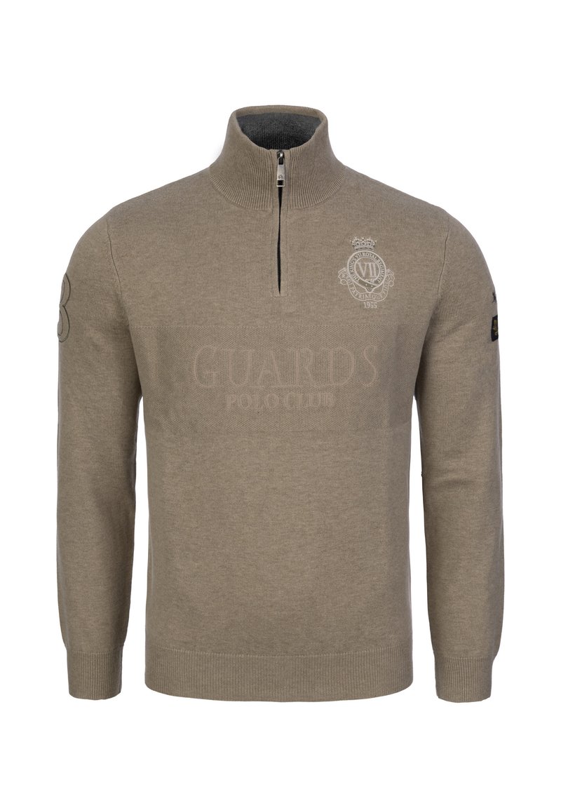 Beżowy sweter z zamkiem i rękawami wykonany z miękkiej dzianiny. Posiada logo w kształcie tarczy na piersi oraz ściągacze przy mankietach i u dołu. Elegancki, minimalistyczny design.