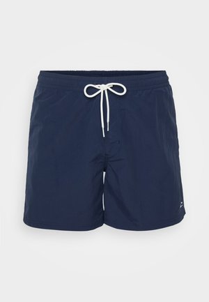 Tengerészkék fürdőnadrág rugalmas derékpánttal és fehér húzózsinórral. Sima állagú, combközép hosszig ér, az oldalon egy kis logóval.