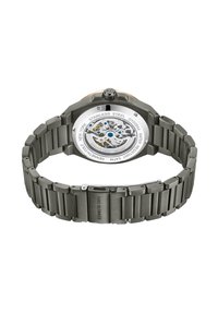 Klocka i rostfritt stål med grått armband, en synlig mekanisk rörelse och en genomskinlig baksida med blå accent.