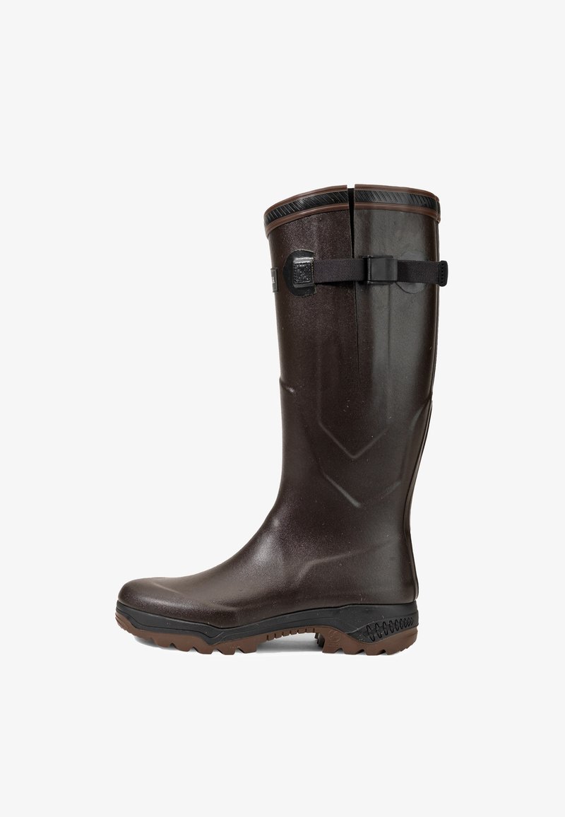 Brown waterproof rubber boot with a textured finish, raised zigzag pattern, and adjustable black strap detail at the calf. Treaded sole.