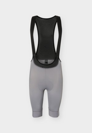 Pantalones cortos de ciclismo con tirantes en color gris, con parte superior trasera de malla negra y tirantes negros, diseñados para brindar comodidad y rendimiento.