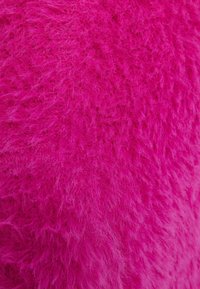 Flauschiger Stoff in leuchtendem Magenta mit einer weichen, strukturierten Oberfläche und feinen, haarähnlichen Fasern, die ein plüschiges Aussehen erzeugen.