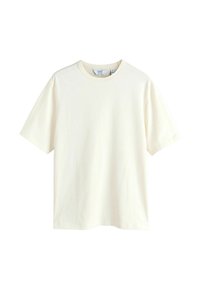 T-shirt uni à manches courtes en coton couleur crème, col rond, taille moyenne, sans logos ni motifs visibles.