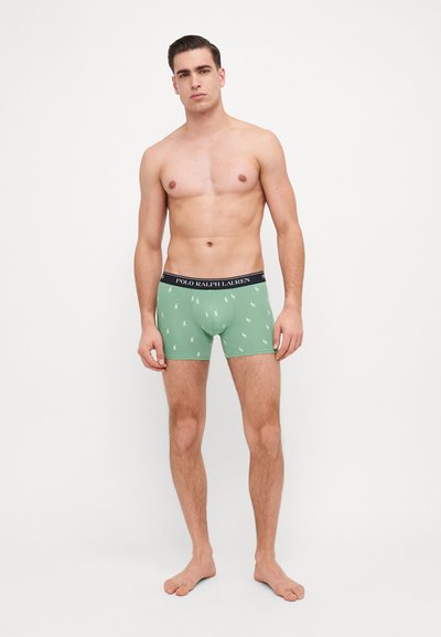 Boxerii din bumbac verde, cu un elastic negru pe care este inscripționat textul "POLO RALPH LAUREN", împodobiți cu un model repetat de logo-uri mici.