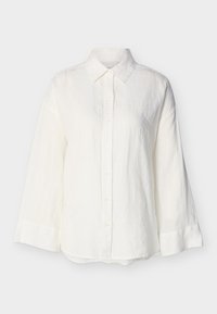 Λευκό πουκάμισο μακρυμάνικο με κουμπιά, μυτερό γιακά και φαρδιές μανσέτες, εμφανίζεται πάνω σε απλό ανοιχτό φόντο.