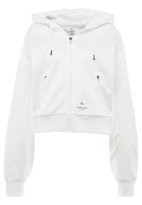 Sweat à capuche court blanc en tissu doux, doté d'une fermeture éclair à l'avant, d'une capuche avec cordon de serrage et de deux poches latérales zippées. Logo Calvin Klein en bas à gauche.