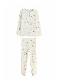 Børnepyjamas sæt i cremegul med et blødt, tekstureret stof. Har lange ærmer og er mønstret med små, multicolorede hjerter.