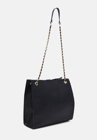 Black tote bag with a smooth texture, gold hardware, and an adjustable chain strap. Features a structured shape and discreet top closure.