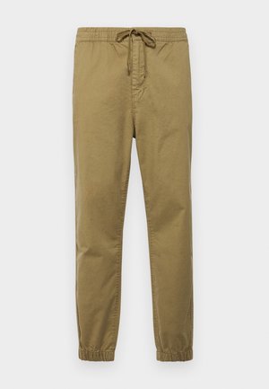 Heledad kangoosid kerge khaki värviga, elastse vöökohaga, reguleeritava nööriga, kitsenevate säärega ja elastsete mansettidega. Siledast ja hingavast kangast.