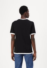 Black short-sleeve t-shirt with white trim on the collar and sleeves, made from a smooth fabric, featuring a relaxed fit and simple design.