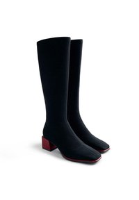 Stivali neri a coste con punta quadrata, dotati di un tacco a blocco rosso a contrasto e una texture liscia, progettati per un silhouette aderente.