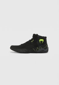 High-top athletic shoes in black mesh and synthetic material, featuring neon green accents, textured sole, and a pronounced side logo.