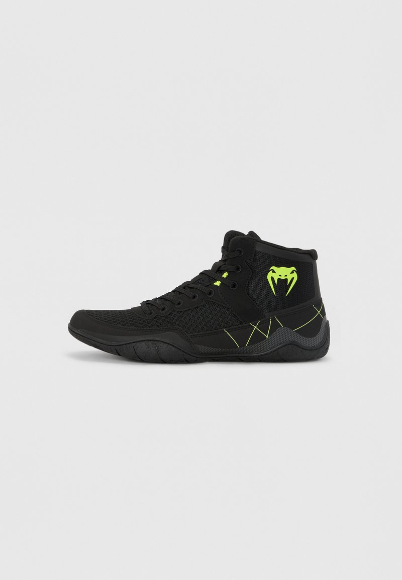 High-top athletic shoes in black mesh and synthetic material, featuring neon green accents, textured sole, and a pronounced side logo.