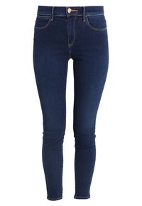 Mörkblå skinny jeans i denim. Har klassisk femficksdesign, dragkedja och subtila stickade detaljer längs sömmarna.