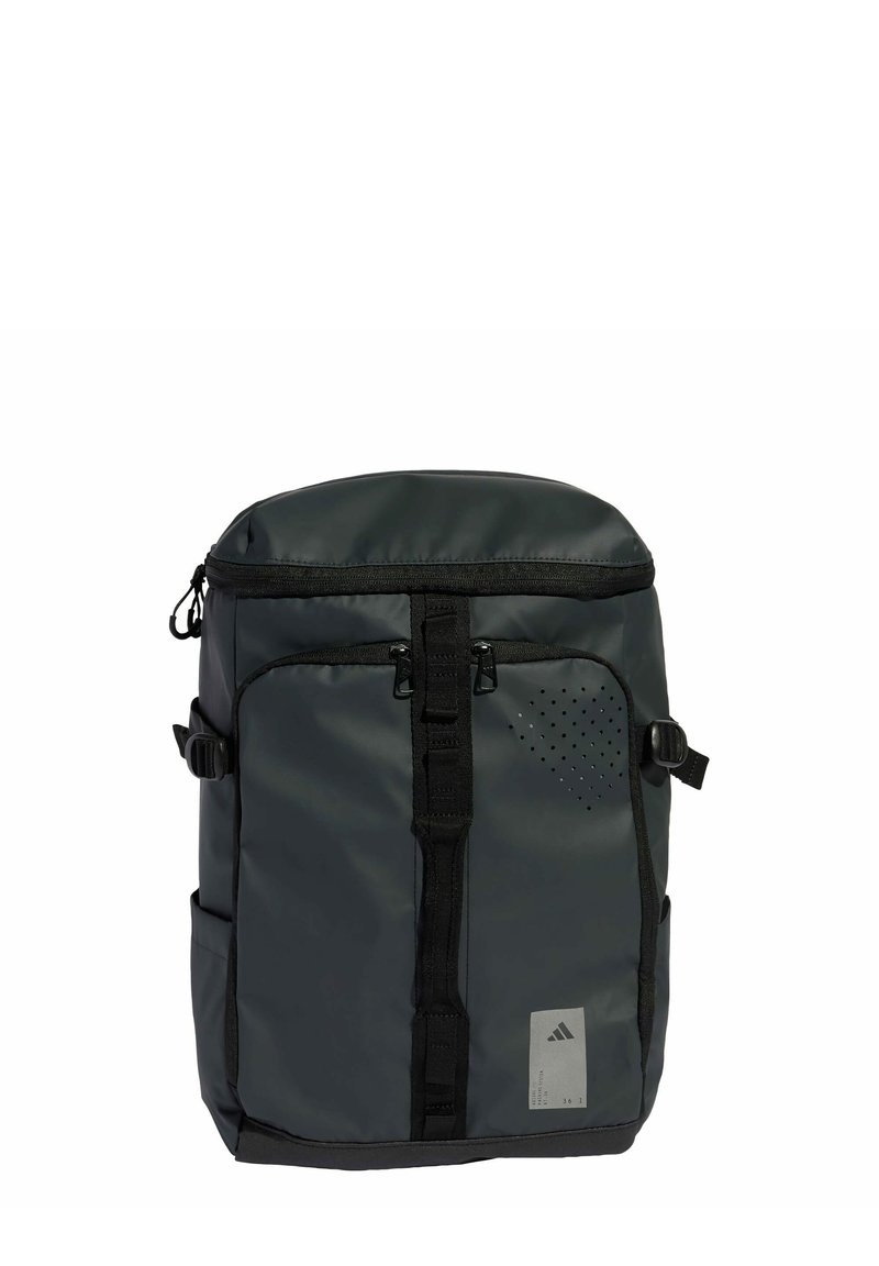 Sac à dos noir, imperméable, avec un dessus rembourré, plusieurs compartiments zippés, des bretelles ajustables et des accents de design perforés.