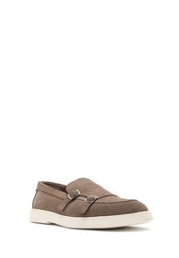 Suede brown slip-on shoe with a white rubber sole, featuring two silver buckle accents and stitched detailing on the upper.