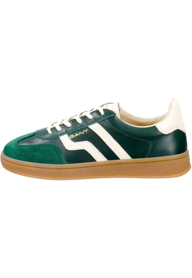 Green and black leather sneakers with white stripes, cream accents, and a gum sole; features laces and branding on the side.