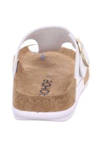 White slide sandal with a textured cork footbed and white outsole. Features a golden buckle detail on the strap and two side openings.