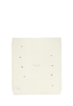 Couverture crème ornée de motifs brodés : ours, abeilles, feuilles et le mot "nanón", avec des bords côtelés. Texture de tissu douce.