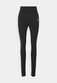 Leggings noirs en tissu extensible avec une taille haute. Présente un petit logo Adidas blanc en haut de la jambe gauche.