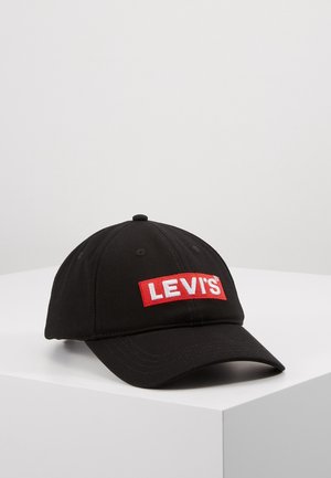 Zwarte baseballpet met een gebogen klep en een rood rechthoekig stuk met het witte Levi's-logo aan de voorkant, geplaatst op een witte ondergrond.