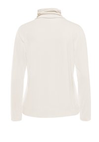 Long-sleeve top in cream fabric with a soft texture, featuring a cowl neckline and a fitted silhouette with no visible closures or patterns.