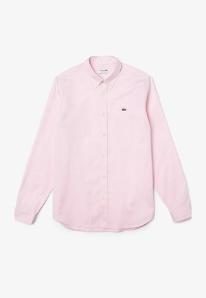 Camicia a maniche lunghe rosa pallido in tessuto di cotone con colletto a punta, dotata di un piccolo logo verde Lacoste sul petto.