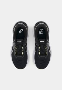 Svarte joggesko med mesh-overdel og syntetiske detaljer. Har gule snøringhighlights, polstret såle og logo på tunga.