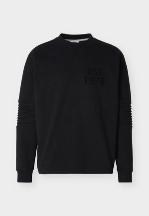 Black long-sleeve sweatshirt with ribbed cuffs, ridged elbow patches, and "EST 1978" printed in black on the upper left chest.