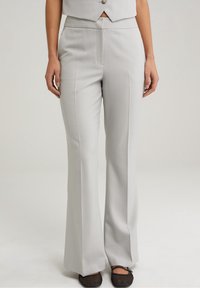 Light gray tailored trousers with a straight-leg fit, featuring front pleats and a mid-rise waistband. Texture appears smooth and fabric is sleek.