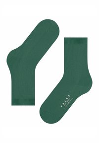 Pair of plain green wool socks laid flat, one showing the sole with size and brand text "FALKE COSY WOOL" printed in white.