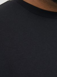 Black cotton t-shirt with a ribbed crew neck. Smooth texture with minimal stitching detail, showcasing a simple and plain design.