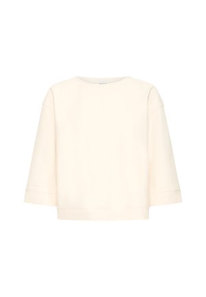 Sweat-shirt à manches longues couleur crème avec un col rond, une coupe décontractée et carrée, et des épaules légèrement tombantes.