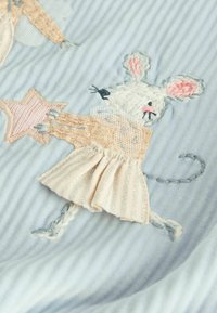 Embroidered mouse design holding a star, featuring pastel colors on a light blue textured fabric. Textured dress with silver accents.
