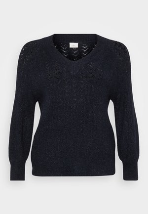 Suéter de punto navy con cuello en V, detalles de calado texturizado en los hombros y mangas largas ligeramente abullonadas. Tejido suave con un ligero brillo.