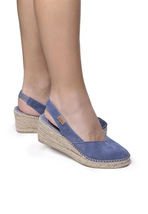 Blue suede wedge sandals with a jute rope platform, open back, and V-shaped front. Features a small logo tag on the side.