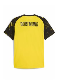 Camiseta de fútbol amarilla y negra del Borussia Dortmund con mangas negras con patrón y texto "DORTMUND" en la parte posterior.