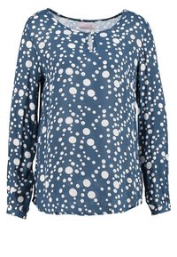 Top a maniche lunghe in tessuto blu scuro con pois bianchi, caratterizzato da un collo rotondo e un dettaglio con bottone sul davanti. Texture liscia.