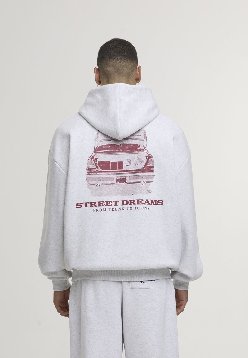 Grey cotton hoodie featuring a rear graphic of a car with the text "STREET DREAMS FROM TRUNK TO ICONS." Loose fit, hooded design.