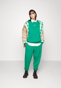 Nike Sportswear PHOENIX W NSW STYLE FLC HR PANT CURVE - Calças de fato de treino - malachite/sail