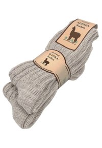 Beige Alpaka-Socken mit gerippter Textur, beschriftet mit "ALPAKA Socken." Enthält eine einfache braune Grafik eines Alpakas auf der Verpackung.