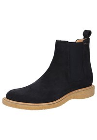 Schwarze Wildleder-Ankle-Boots mit elastischen Seitenpaneelen, runder Zehenpartie und einer hellen Gummisohle. Genähte Details entlang der Sohlenkante.
