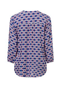 Blusa a maniche lunghe con motivo circolare multicolore in blu, rosso e bianco, con orlo arrotondato e uno sprone posteriore con bottoni.