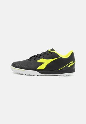 Black athletic shoe with neon yellow accents, including logo and inner lining, and a white textured sole, shown from the side.