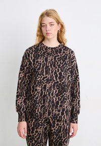 Melnā un brūnā leoparda raksta sporta krekls, ar apaļu kaklu, br�īvu piegriezumu, mīkstu audumu un garām piedurknēm, saskaņots ar atbilstošām biksēm.