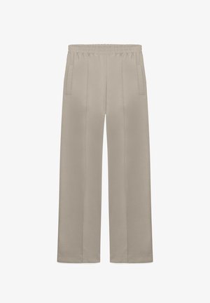 Bézs egyenes szárú nadrág rugalmas derékpánttal és oldalzsebekkel, elülső hajtásokkal és lazább szabással.